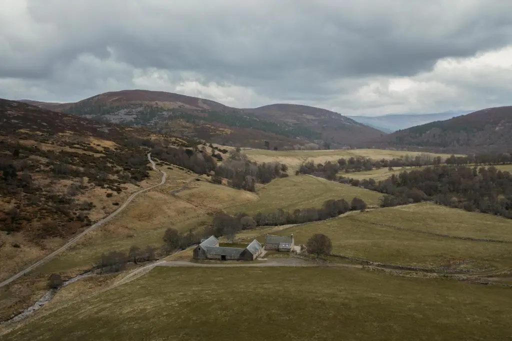 an aerial view of a house in the middle of a field at Inverenzie Cottage, Rooms with a view! in Coilacriech
