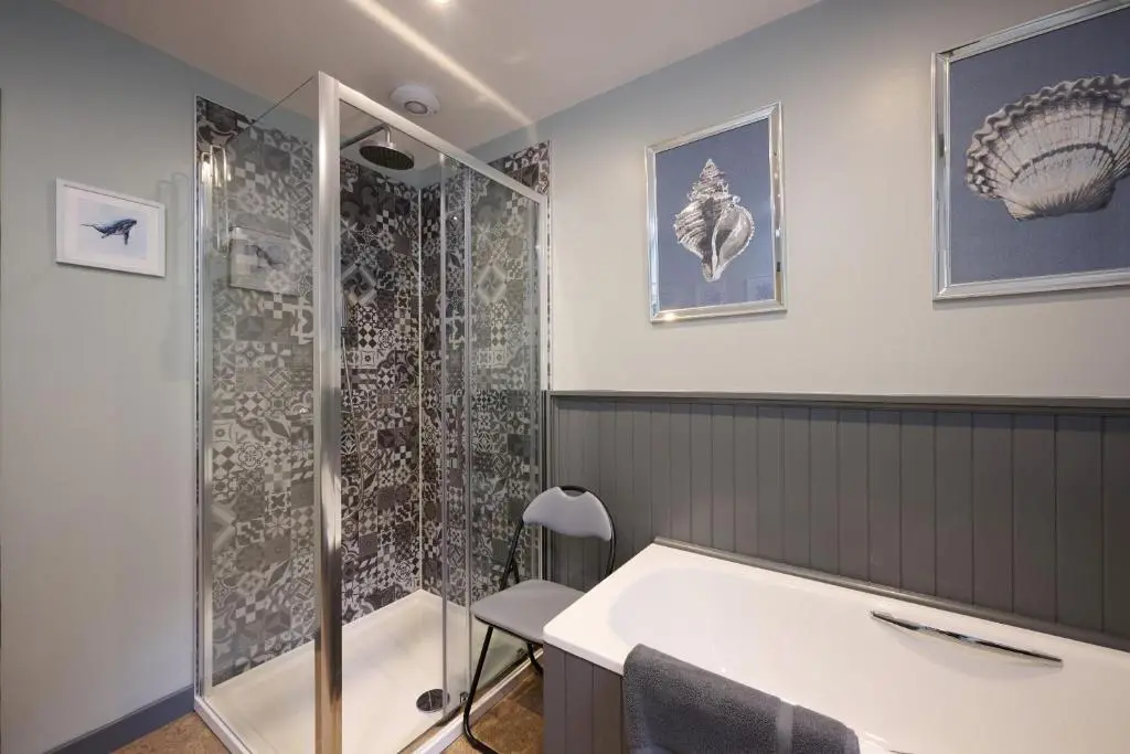 a bathroom with a shower and a sink at Glen View in Inverness