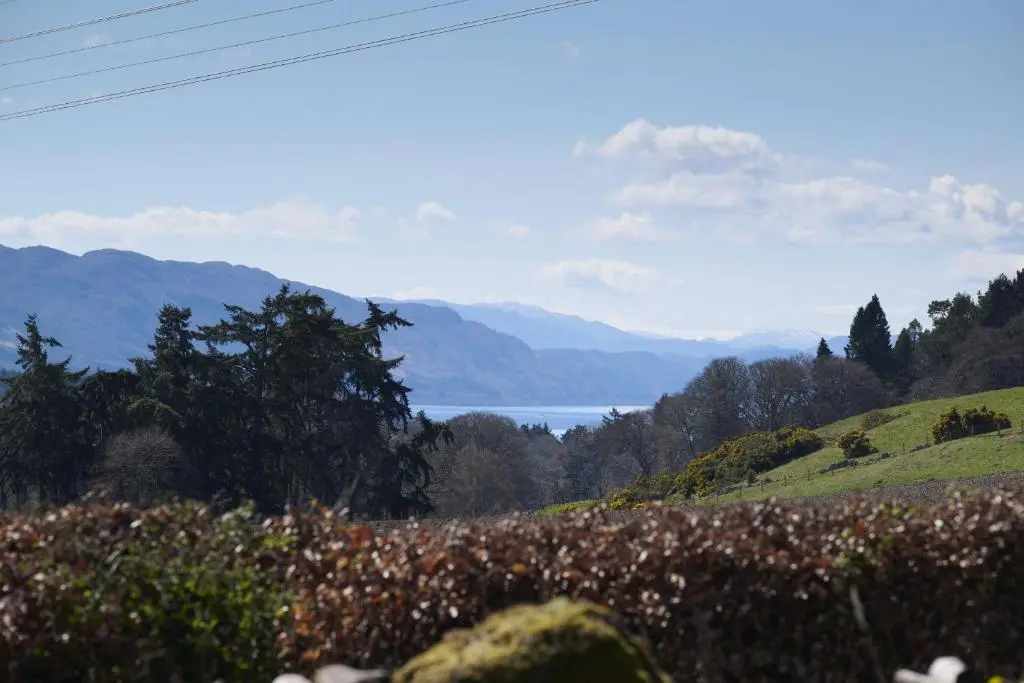 a view of a valley with mountains and a lake at Glen View in Inverness