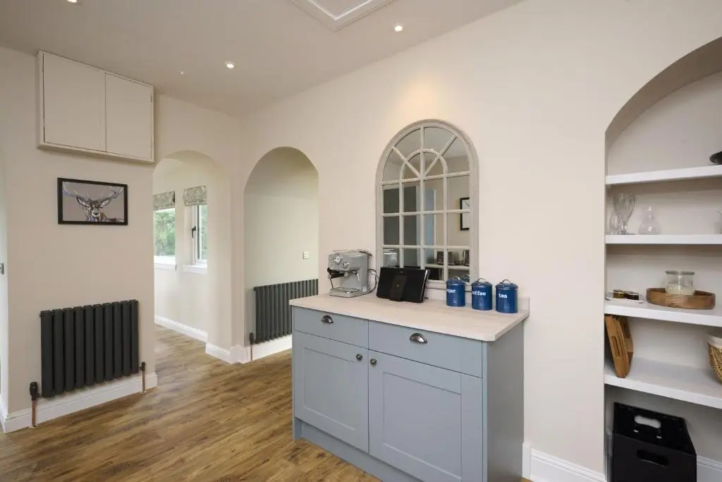 a kitchen with white cabinets and a counter top at Middleton Farmhouse in Inverness