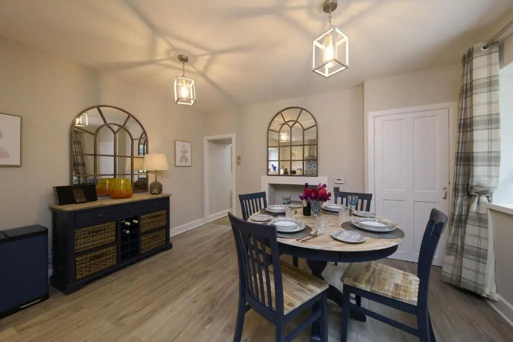 a dining room with a table and chairs at Upper Dunain in Inverness