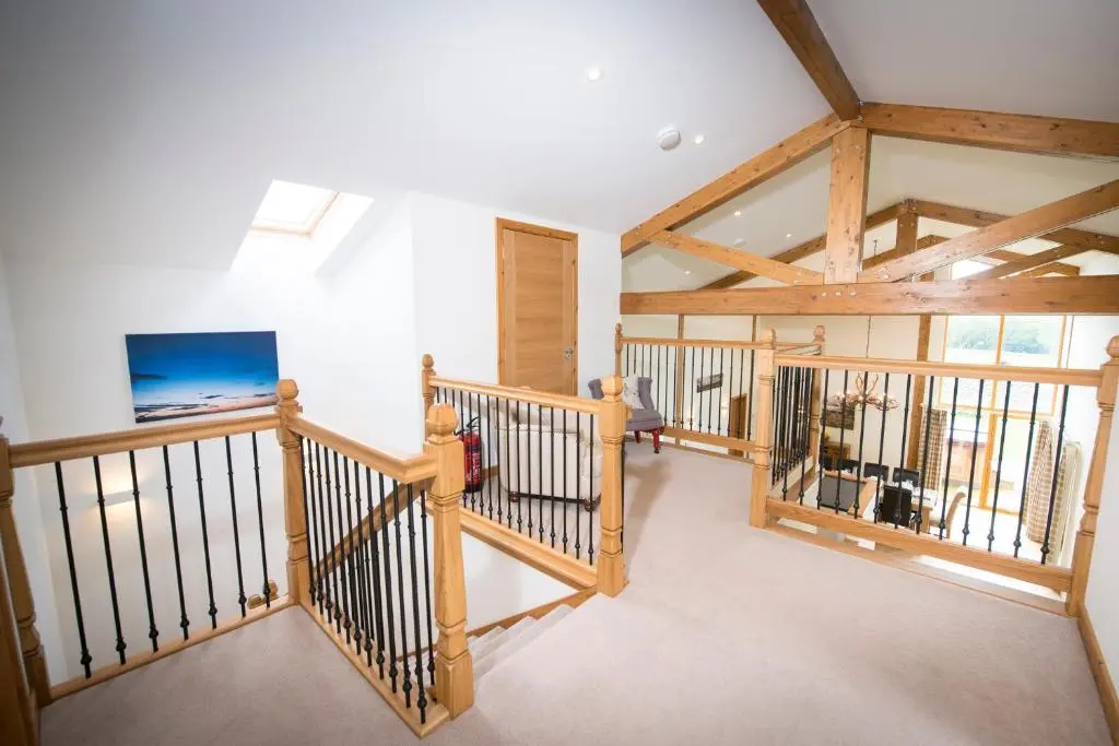 a room with a staircase with wooden beams at Atlas in Nairn