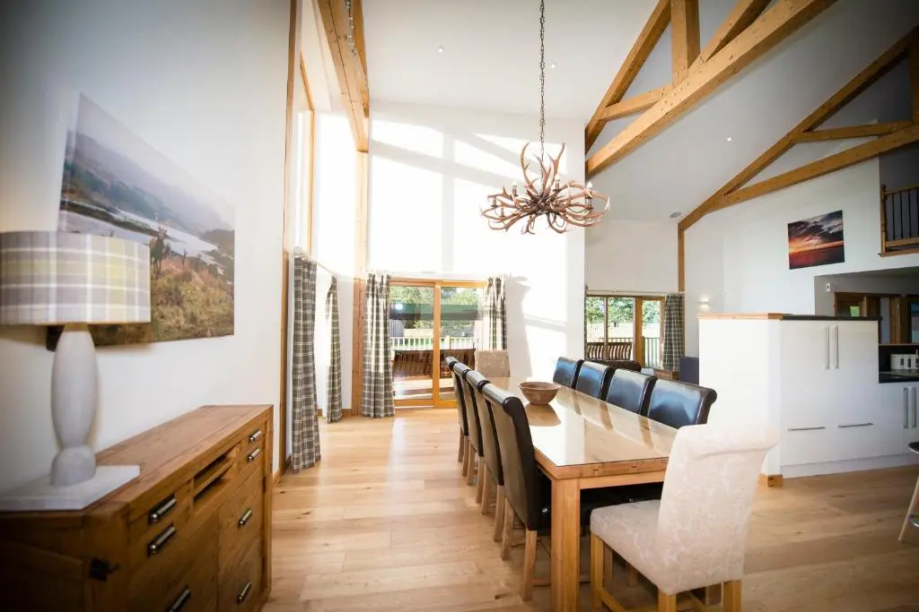 a dining room with a table and chairs at Atlas in Nairn