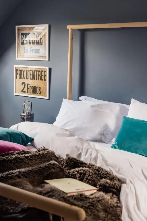a bedroom with a bed with a book on it at The Hayloft in Banchory