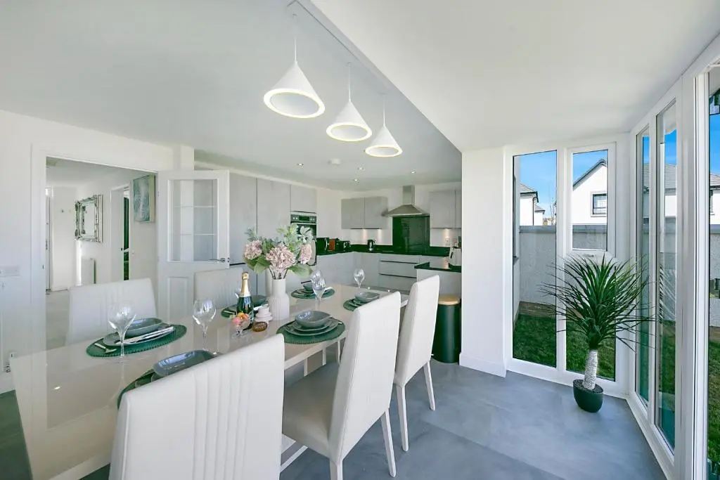 a kitchen and dining room with a table and chairs at Fern Place Villa - Grampian Lettings Ltd in West Cults
