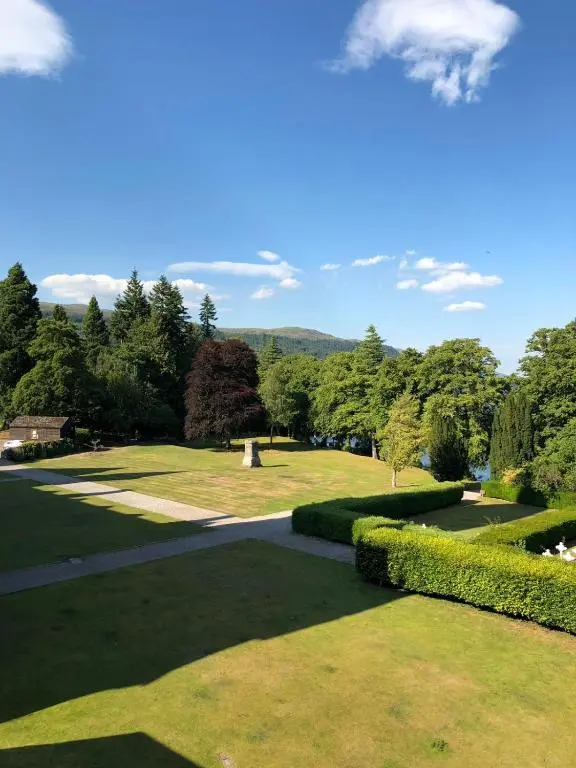 a view of a park with trees and grass at The Highland Club in Fort Augustus