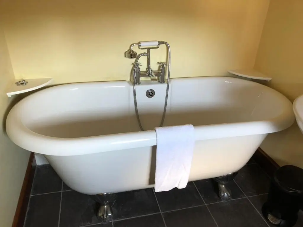 a white bath tub with a faucet in a bathroom at The Highland Club in Fort Augustus