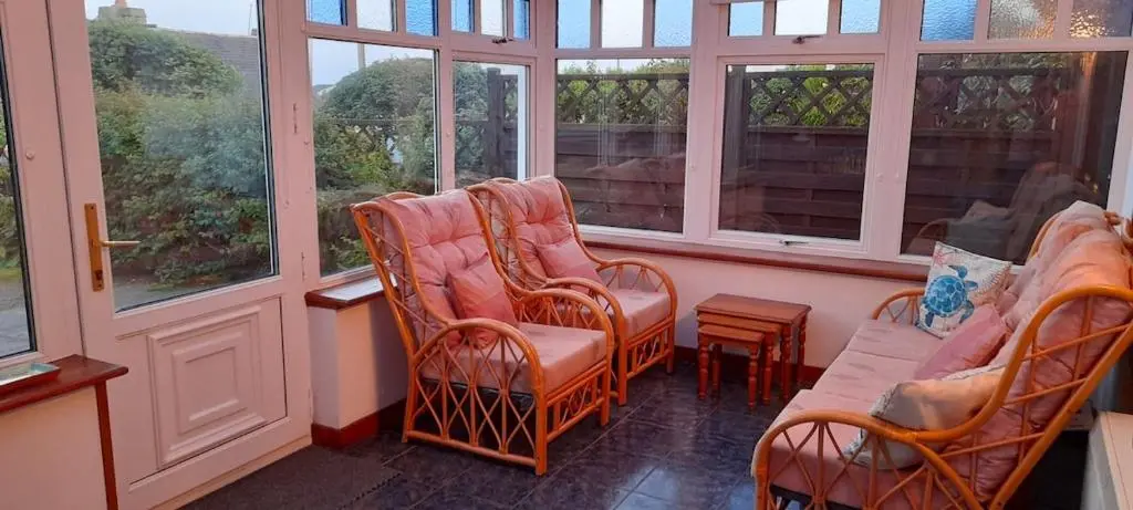 a room with chairs and a couch and windows at Sunnyside Cottage 2 Bedrooms 1 Bathroom 1 WC 2 Pets Welcome in Hilton of Cadboll