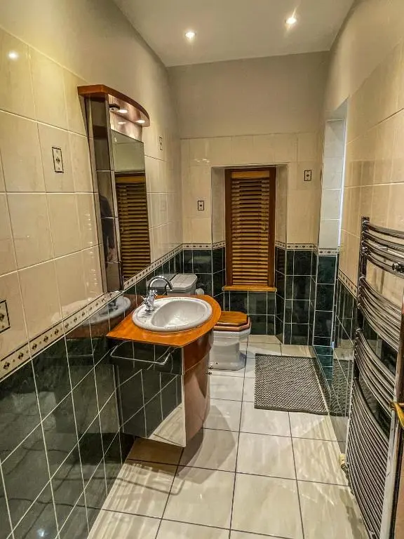 a bathroom with a sink and a toilet at Cathedral Apartment in Inverness