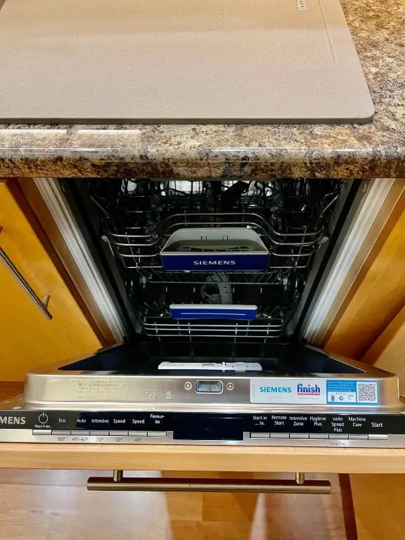 a appliance sitting on top of a laptop under a counter at Cathedral Apartment in Inverness