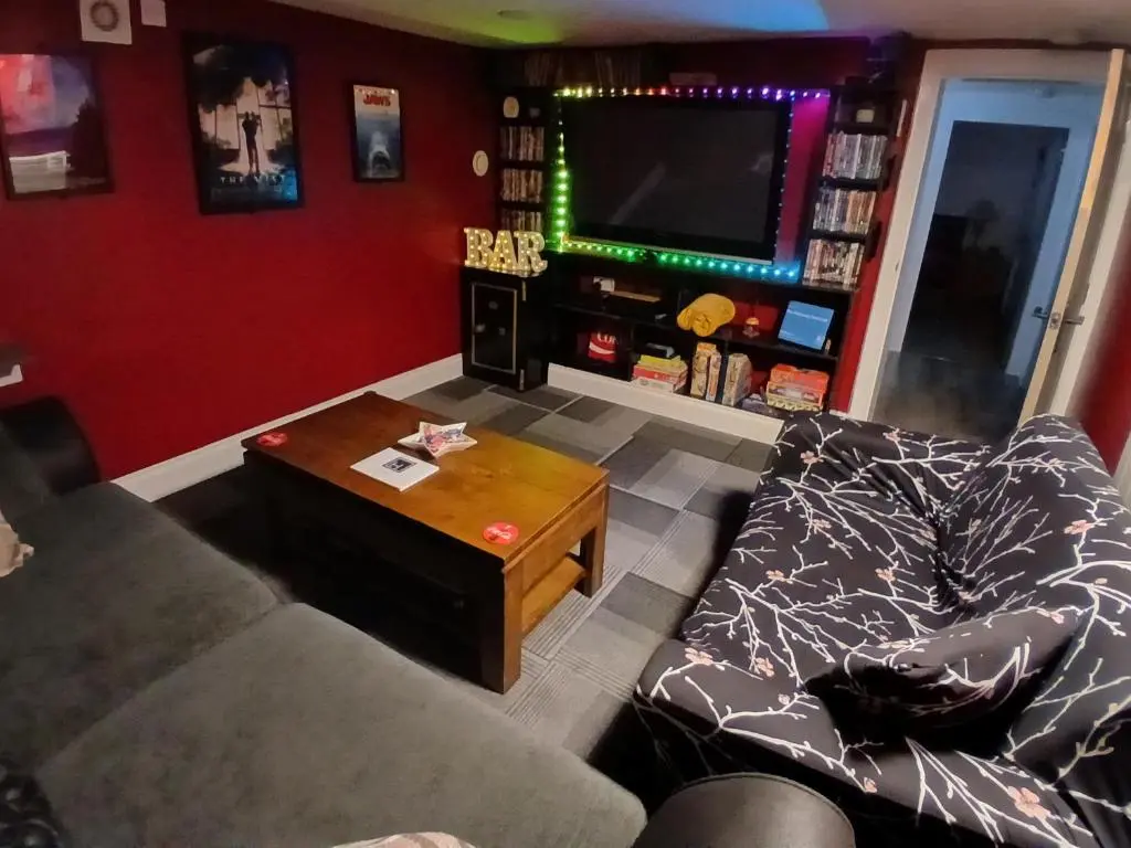 a living room with a couch and a tv at The Hideaway Inverurie in Inverurie