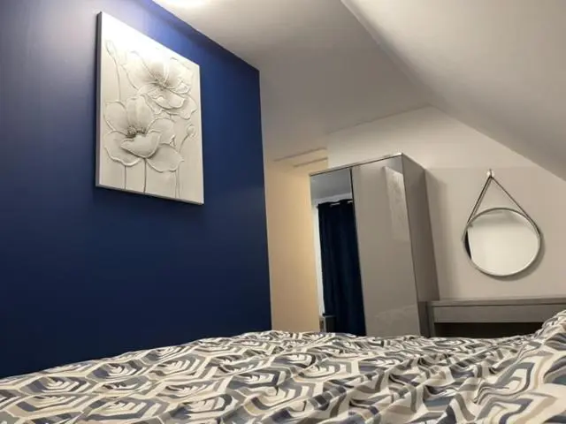 a bedroom with a bed and a painting on the wall at Lochside Loft - Self Catering Apartment for 2 In a great location for Inverness Airport and both Cabot Highlands & Nairn Golf Courses in Inverness