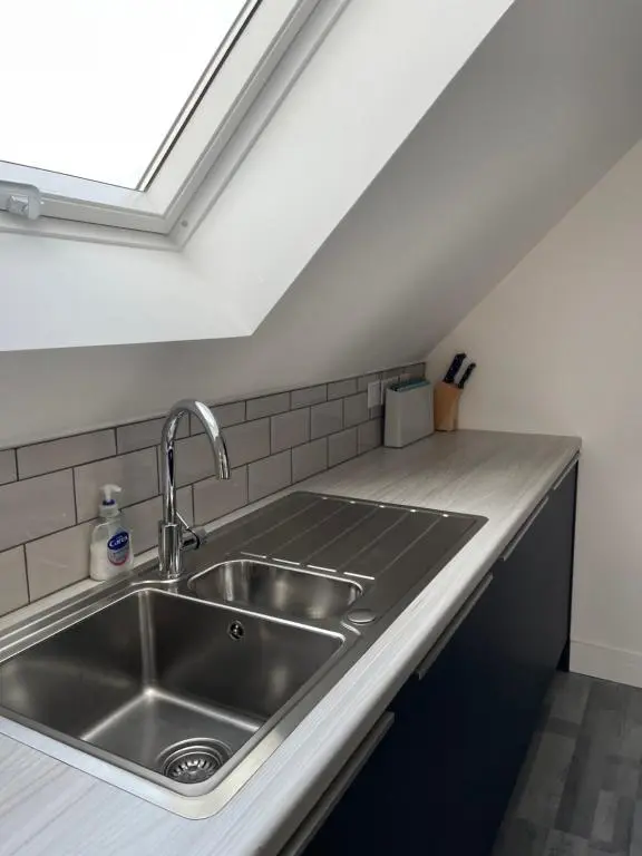 a kitchen with a sink and a skylight at Lochside Loft - Self Catering Apartment for 2 In a great location for Inverness Airport and both Cabot Highlands & Nairn Golf Courses in Inverness