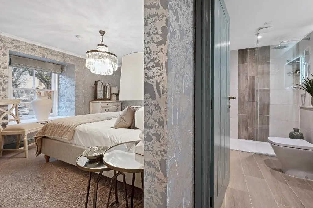 a bedroom with a king sized bed and a bathroom at Cathedral House in Dornoch