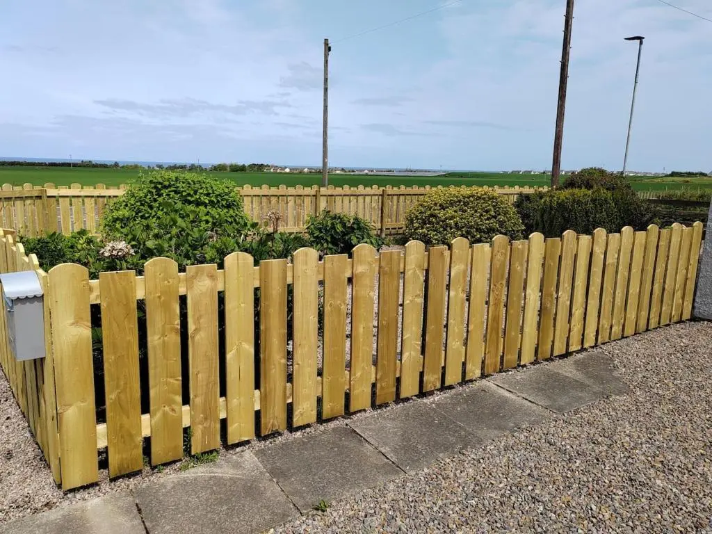 a wooden fence in front of a garden at Westview in Buckie