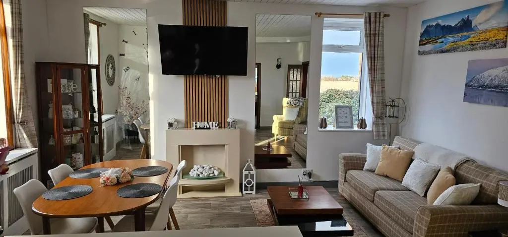 a living room with a table and a couch at Westview in Buckie