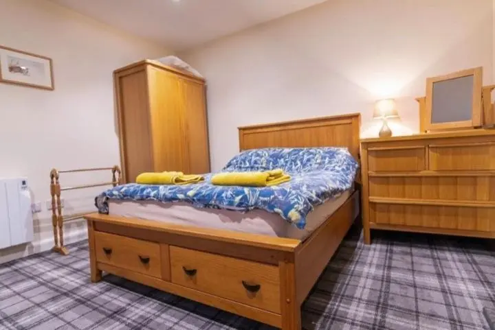a bedroom with a bed with two bananas on it at 176 Marrell in Helmsdale