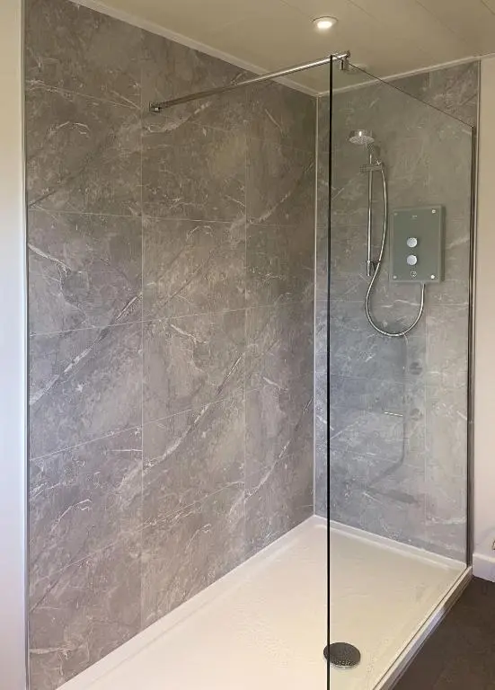 a bathroom with a shower with a glass door at Aonach in Kingussie