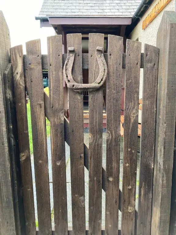 a wooden fence with a snake on it at Smithy Cottage in Strathdon