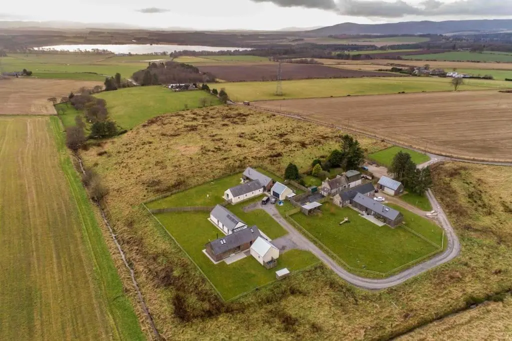an aerial view of a house in a field at Architect Designed Lodge in Dunecht
