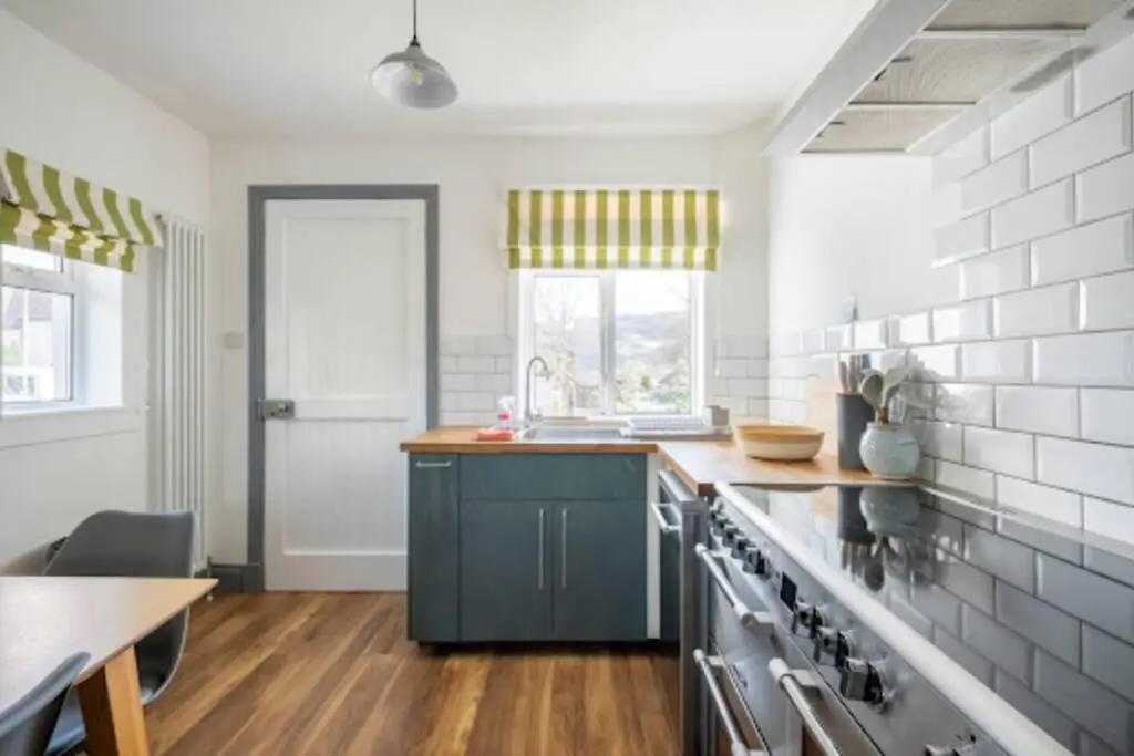 a kitchen with a sink and a stove top oven at Cosy Hygge/ Scottish themed home by Loch Ness in Fort Augustus
