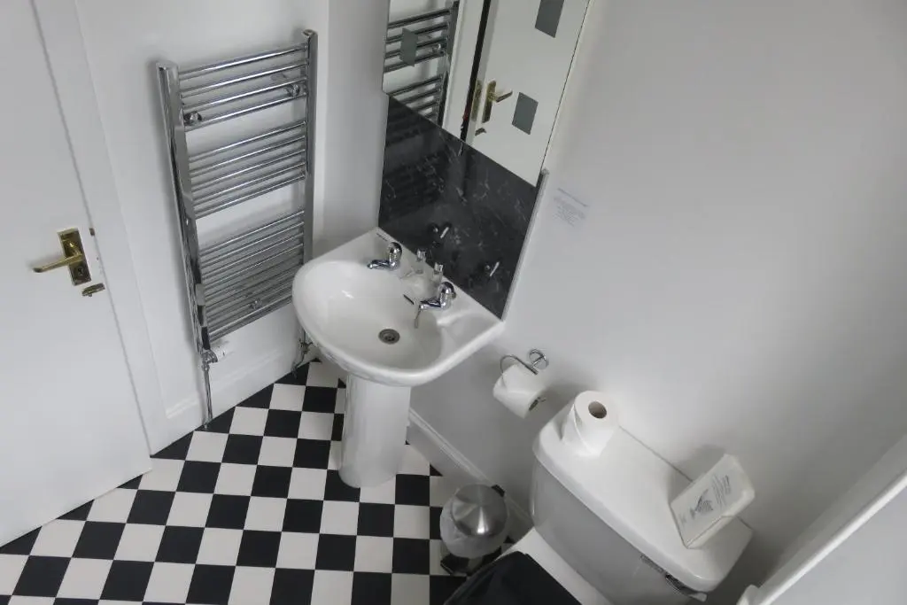 a bathroom with a sink and a toilet at West End Guest House in Elgin