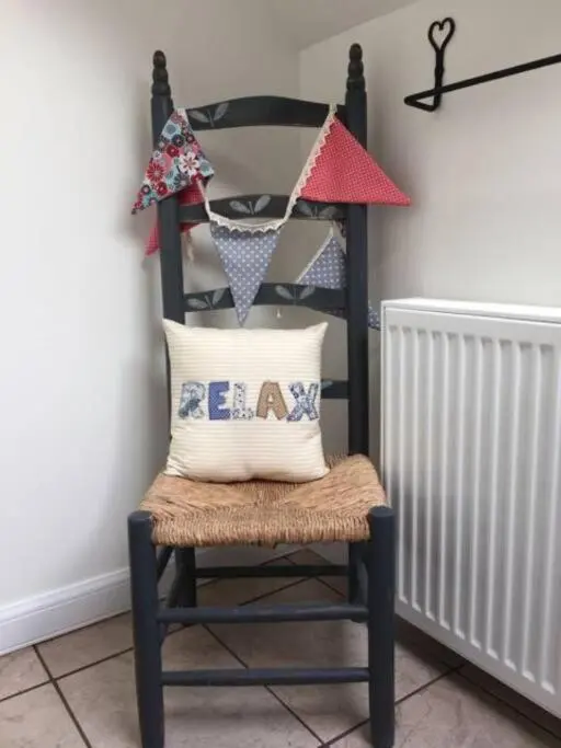 a black chair with a pillow on top of it at Upper Corronich in Boat of Garten