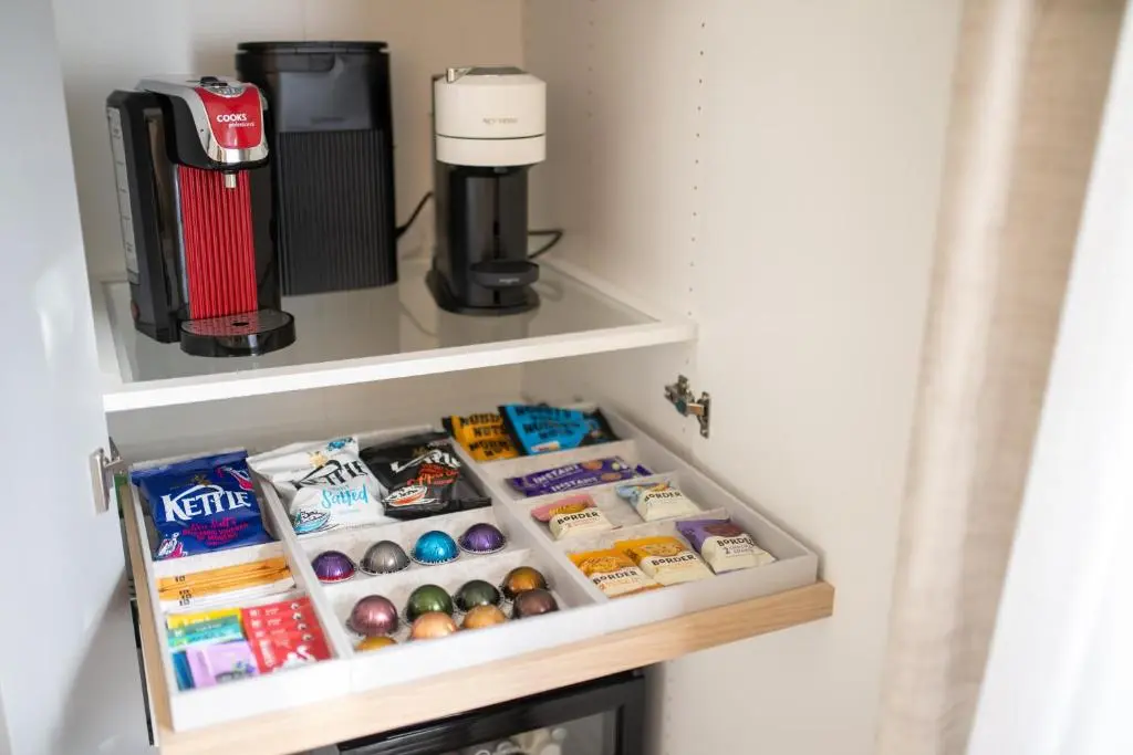 a cupboard filled with food and a coffee maker at The Koko Rooms in Inverness