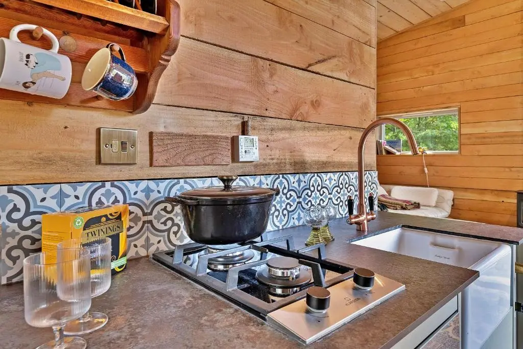 a kitchen with a stove with a pot on it at Finest Retreats - Cosagach Falls Cabin in Kiltarlty