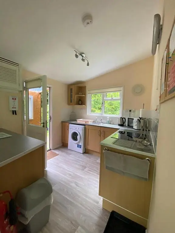 a kitchen with a sink and a stove at Baillie Chalet on Reelig Estate in Kirkhill
