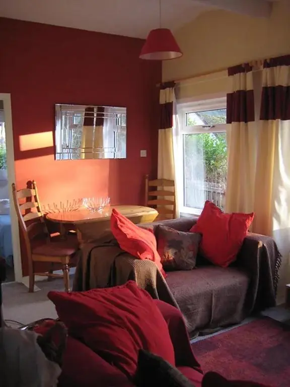 a living room with a couch and a table at Satchwell Chalet on Reelig Estate - Dog Friendly in Kirkhill