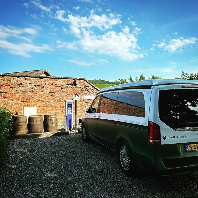 a green and white van parked in front of a brick building at The Cooper's Van - Beautiful, luxury static caravan in Aberlour