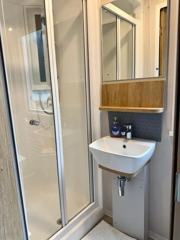 a bathroom with a shower and a sink at The Cooper's Van - Beautiful, luxury static caravan in Aberlour
