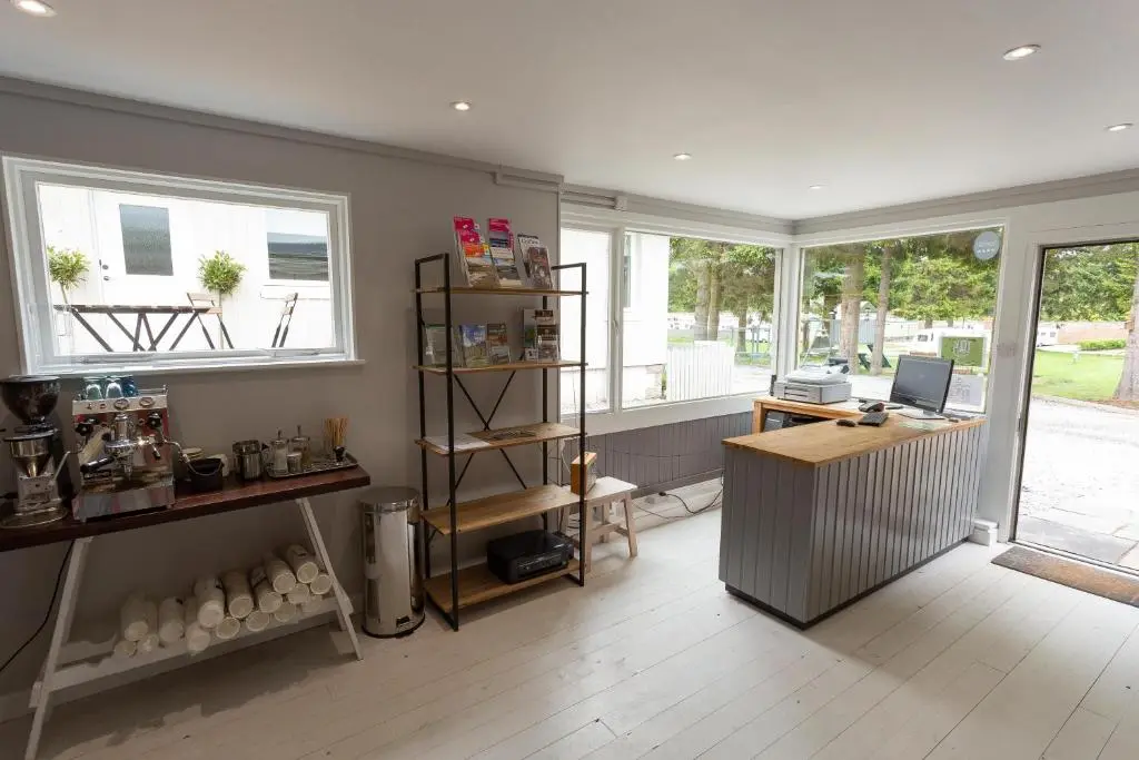 an office with a desk and a computer in a room at The Distiller\u2019s Van - Beautiful, luxury static caravan in Aberlour