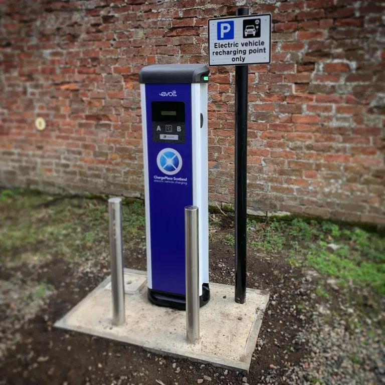 a blue parking meter sitting next to a brick wall at The Distiller\u2019s Van - Beautiful, luxury static caravan in Aberlour