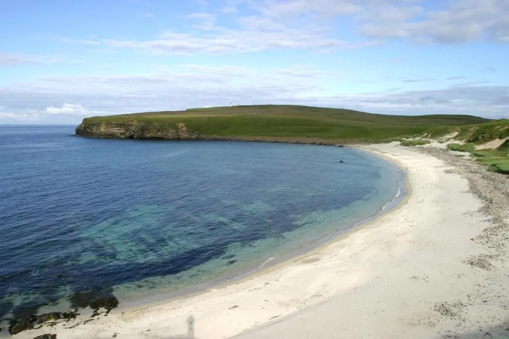 a view of a sandy beach next to the ocean at Craiglea Lodge in Latheron