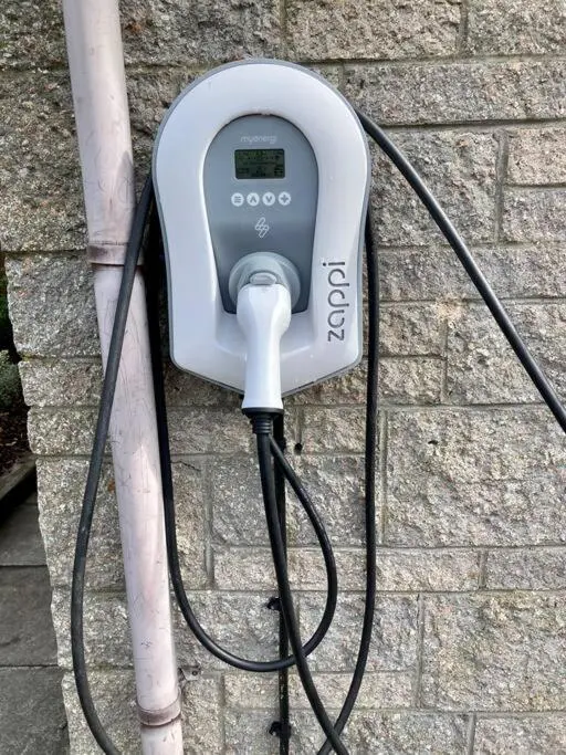 a pay phone is hooked up to a brick wall at 3-Bedroom Eco-house with EV charger. in Rosemarkie