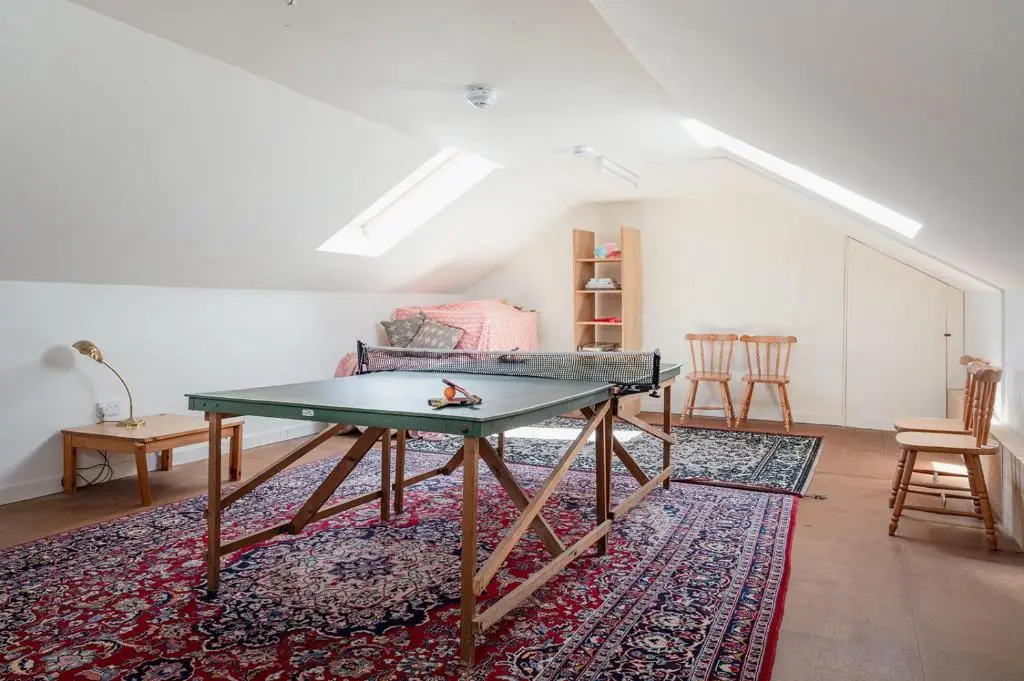 a ping pong table in a living room with a couch at Milton Lodge - Seasgair Lodges in Newtonmore