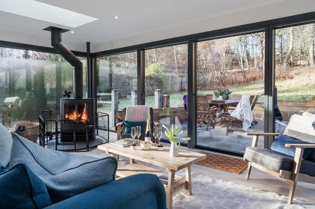 a living room filled with furniture and a fireplace at Oak Cottage - Seasgair Lodges in Kincraig