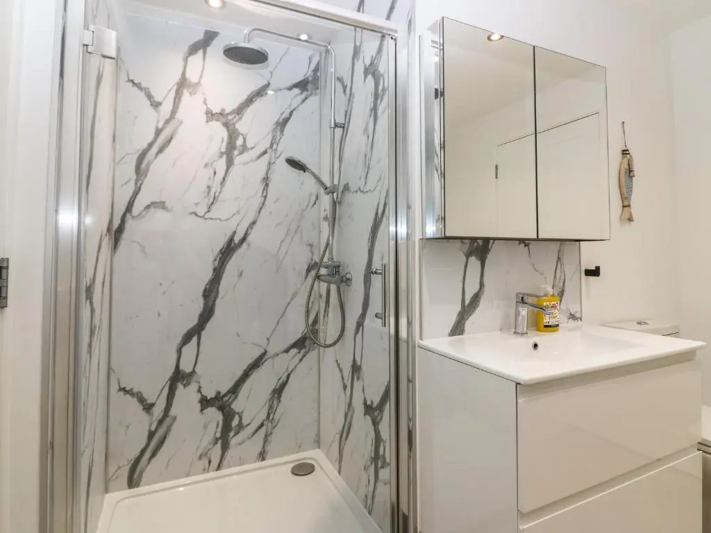 a bathroom with a shower and a sink at Craignure in Banff