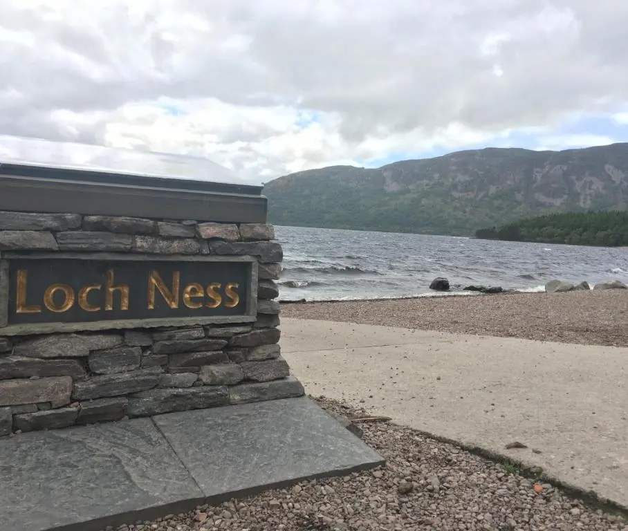 a sign for loch ness on the shore of a beach at Comfortable, modern apartment with parking. Inverness. in Inverness