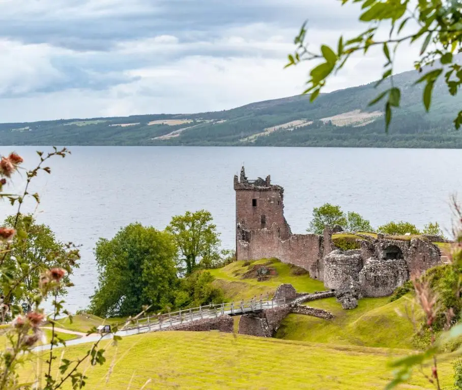 a castle on a island in the middle of a body of water at Comfortable, modern apartment with parking. Inverness. in Inverness