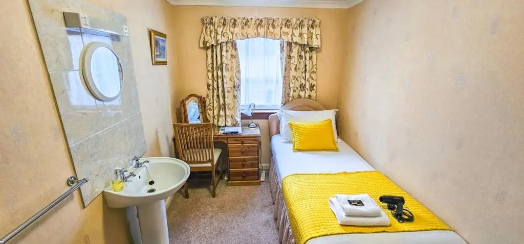 a small room with two beds and a sink and a sink at mySTAYINN Abermar Guest House in Inverness