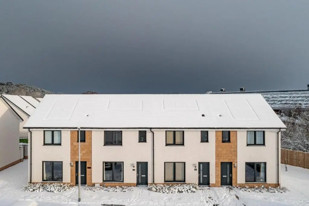 a white house with a snow covered roof at Fletcher's Gate in Inverness
