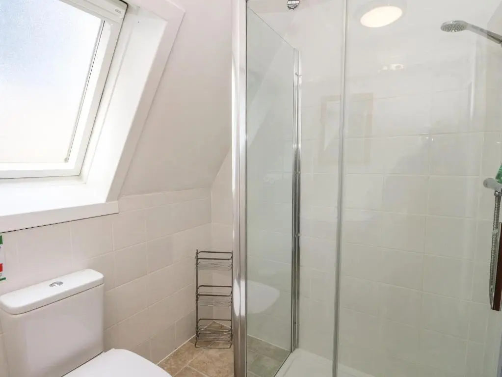 a bathroom with a shower and a toilet at 27 Invergarry Lodges in Spean Bridge