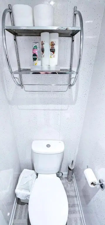 a bathroom with a toilet and a shelf above it at mySTAYINN Kinloch 7 Bedroom House in Inverness
