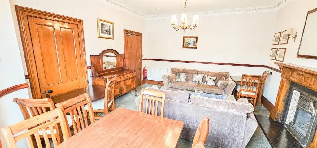 a living room with a couch and a table at mySTAYINN Melrose Villa in Inverness