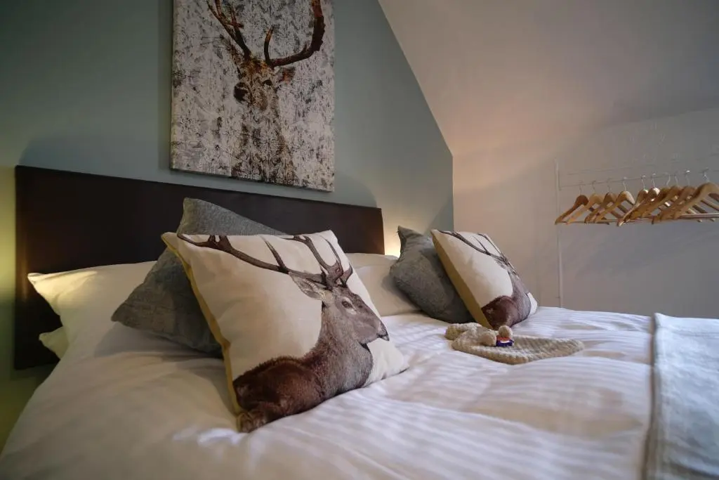 a bed with a picture of a deer on it at Morlea Bed & Breakfast in Drumnadrochit