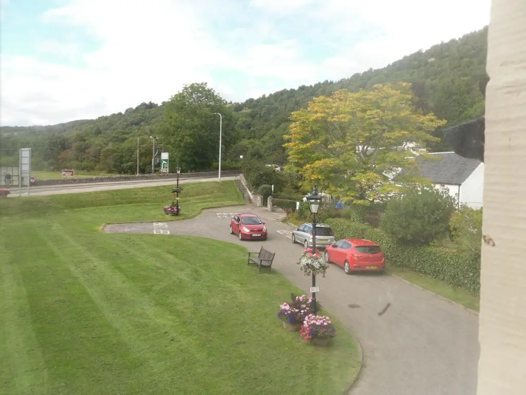 a group of cars driving down a road at Morlea Bed & Breakfast in Drumnadrochit