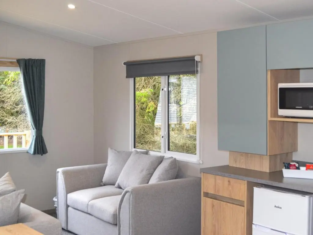 a living room with a couch and a window at The Finch in Dyke